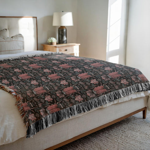 Luxurious woven cotton throw blanket featuring symmetrical scarab beetle pattern in terracotta on black background with white fringe detail. Perfect as gothic wall tapestry, dark academia decor, or cottagecore blanket for bedroom or living room.